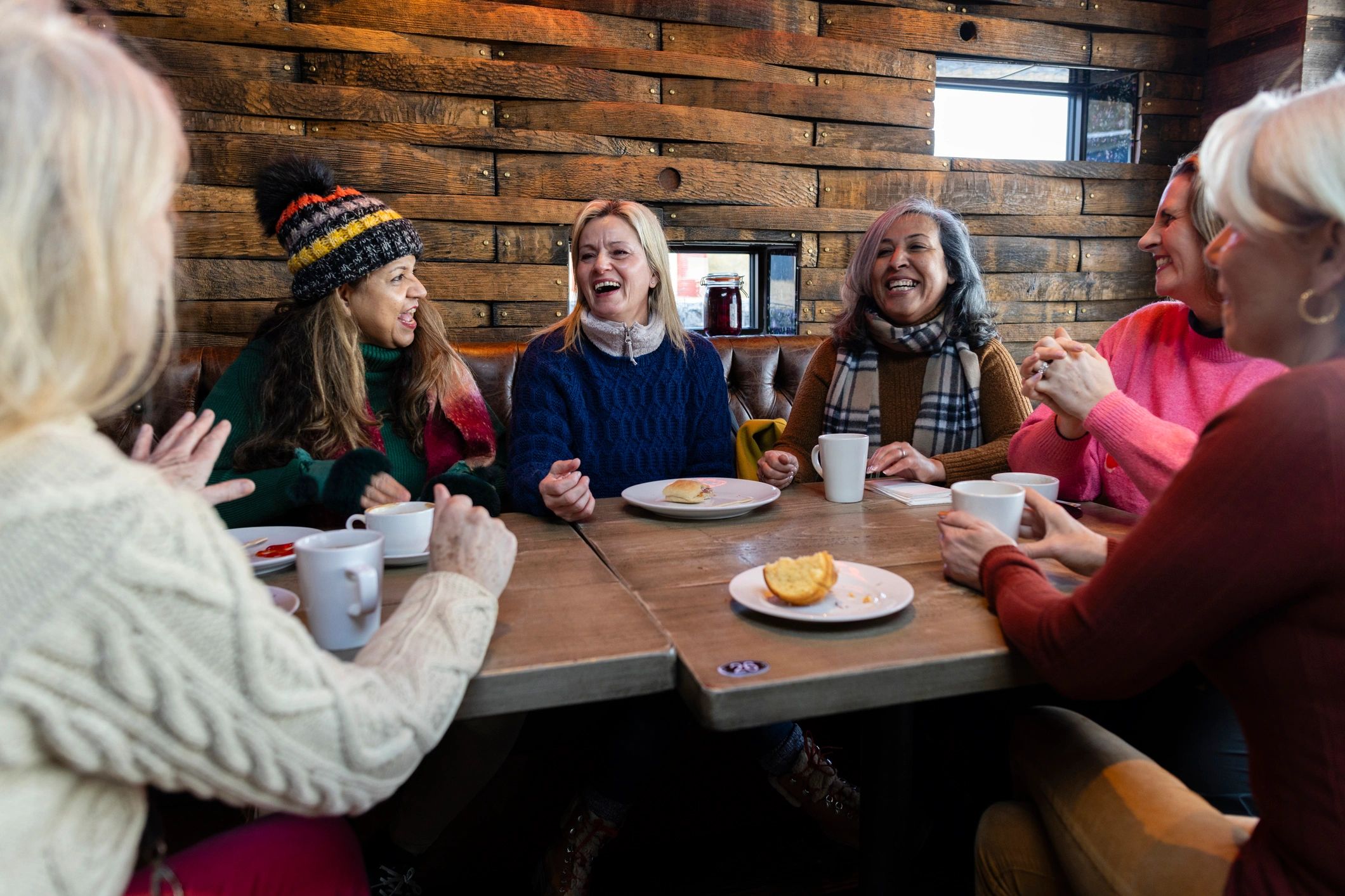 Guests sharing coffee and conversation in a café