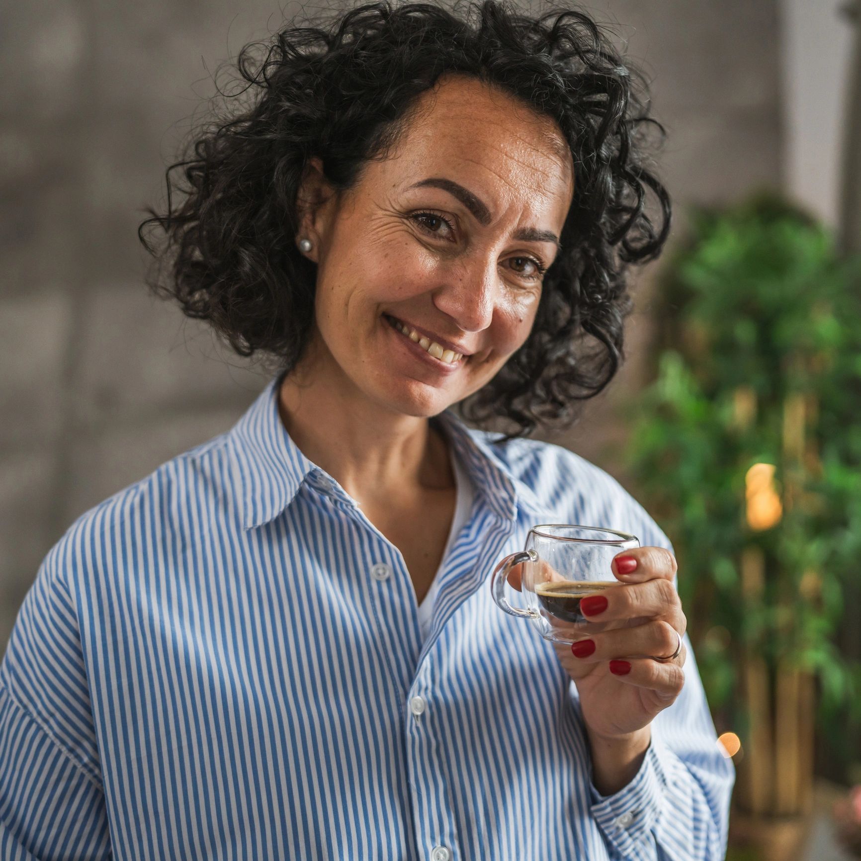 Portrait of happy customer holding coffee