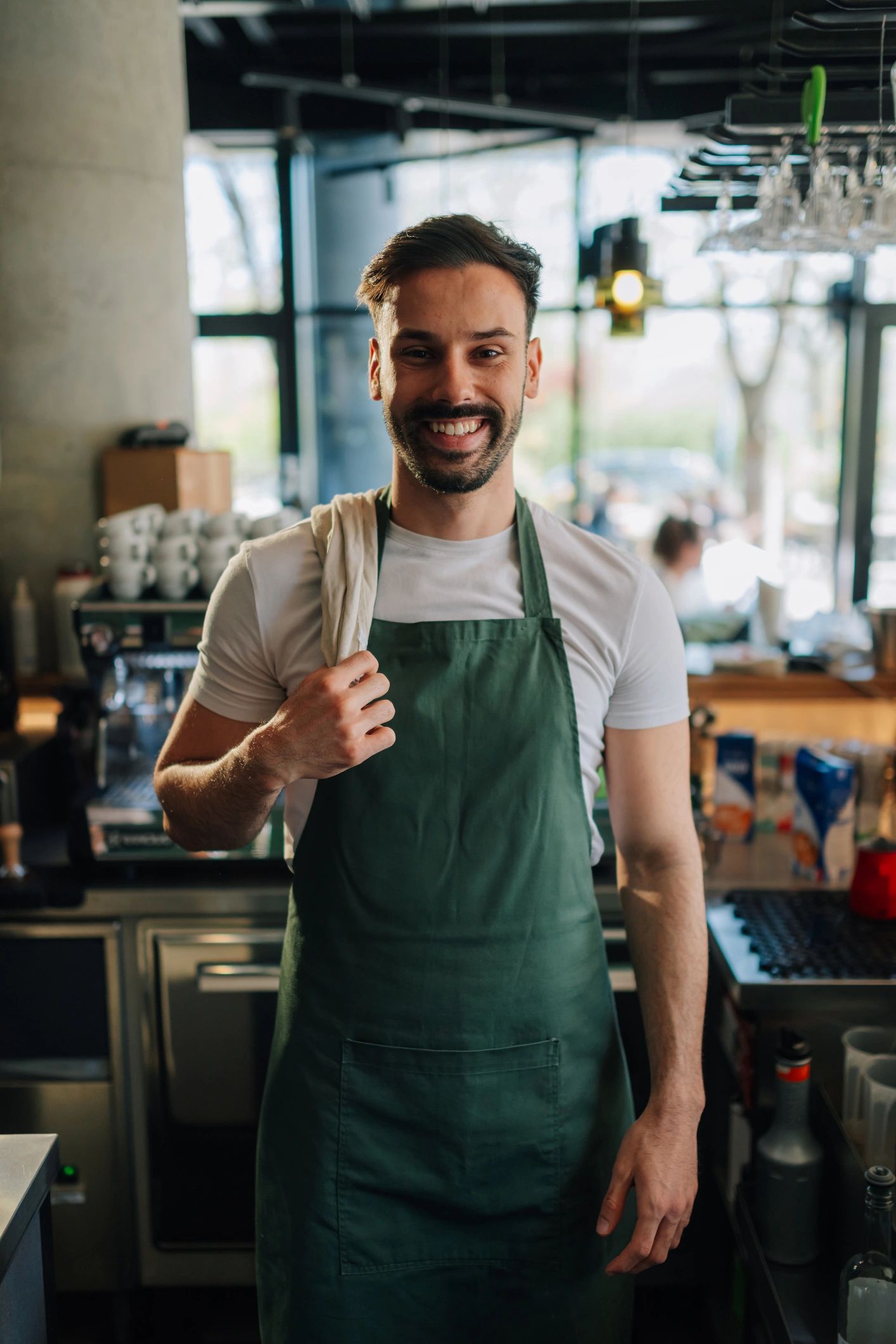 Portrait of a smiling barista in an apron