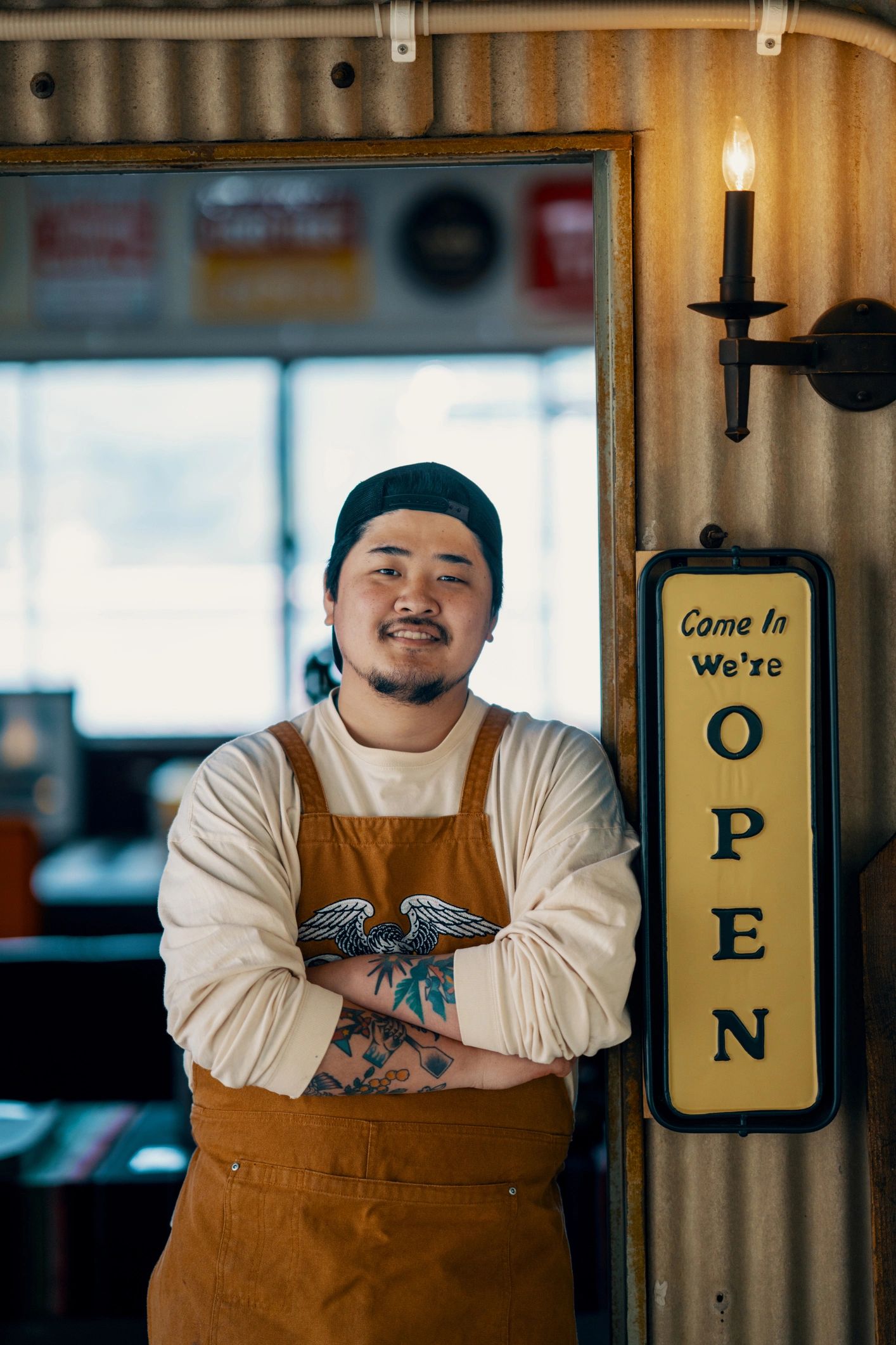 Portrait of café team member standing confidently