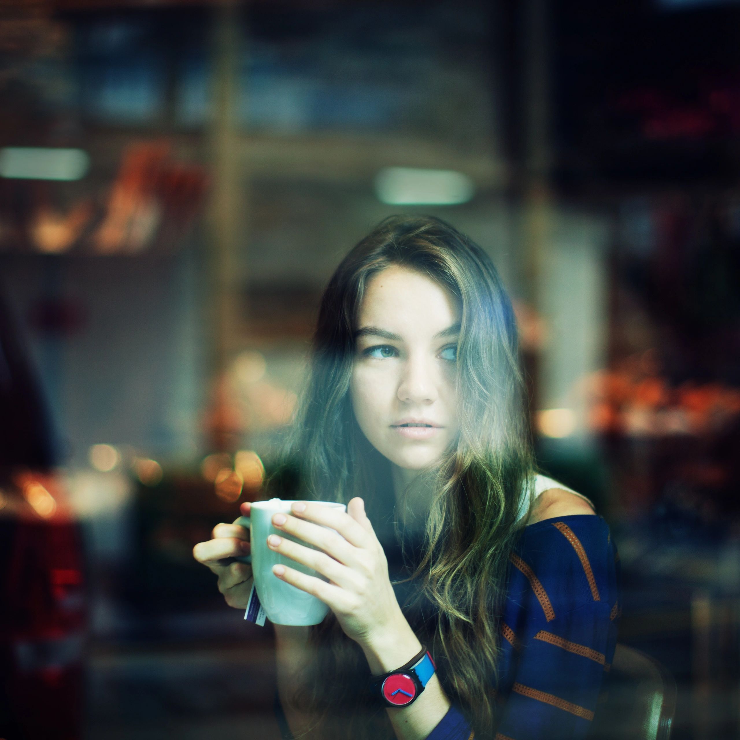 Portrait of café guest with warm drink
